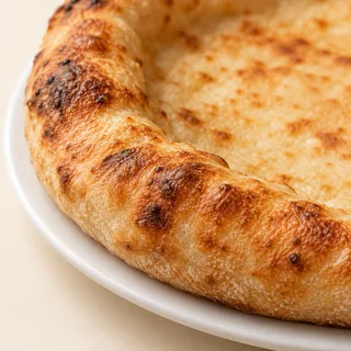Detalhe ilustrativo compartilhado da família de pizza; não representa todos os ingredientes de Pizza Carne seca